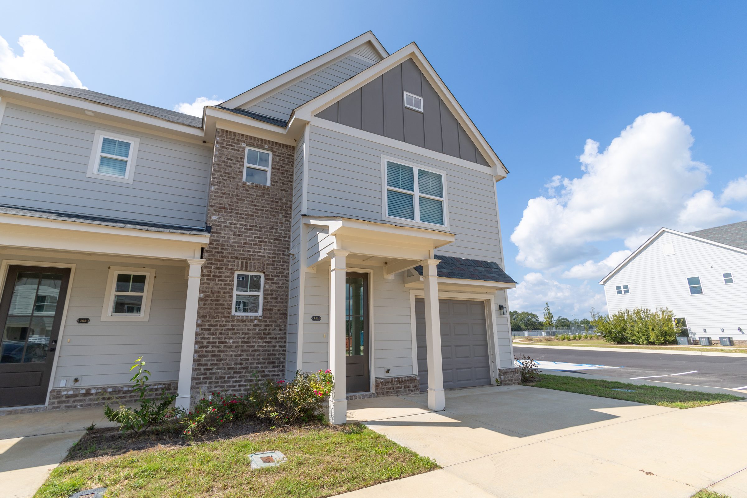 Corner townhome with garage and landscaped entry