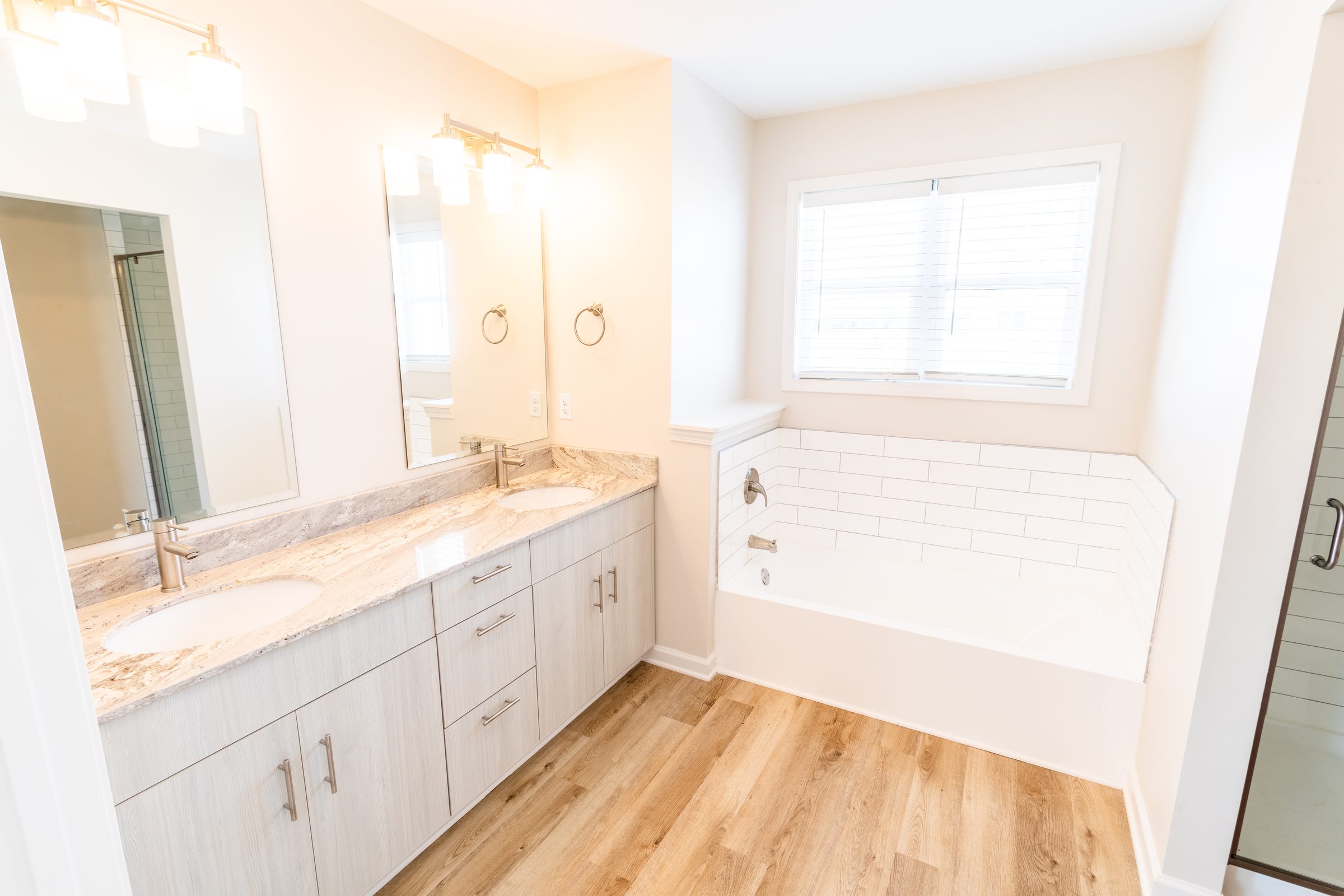 Primary bathroom with double vanity and soaking tub
