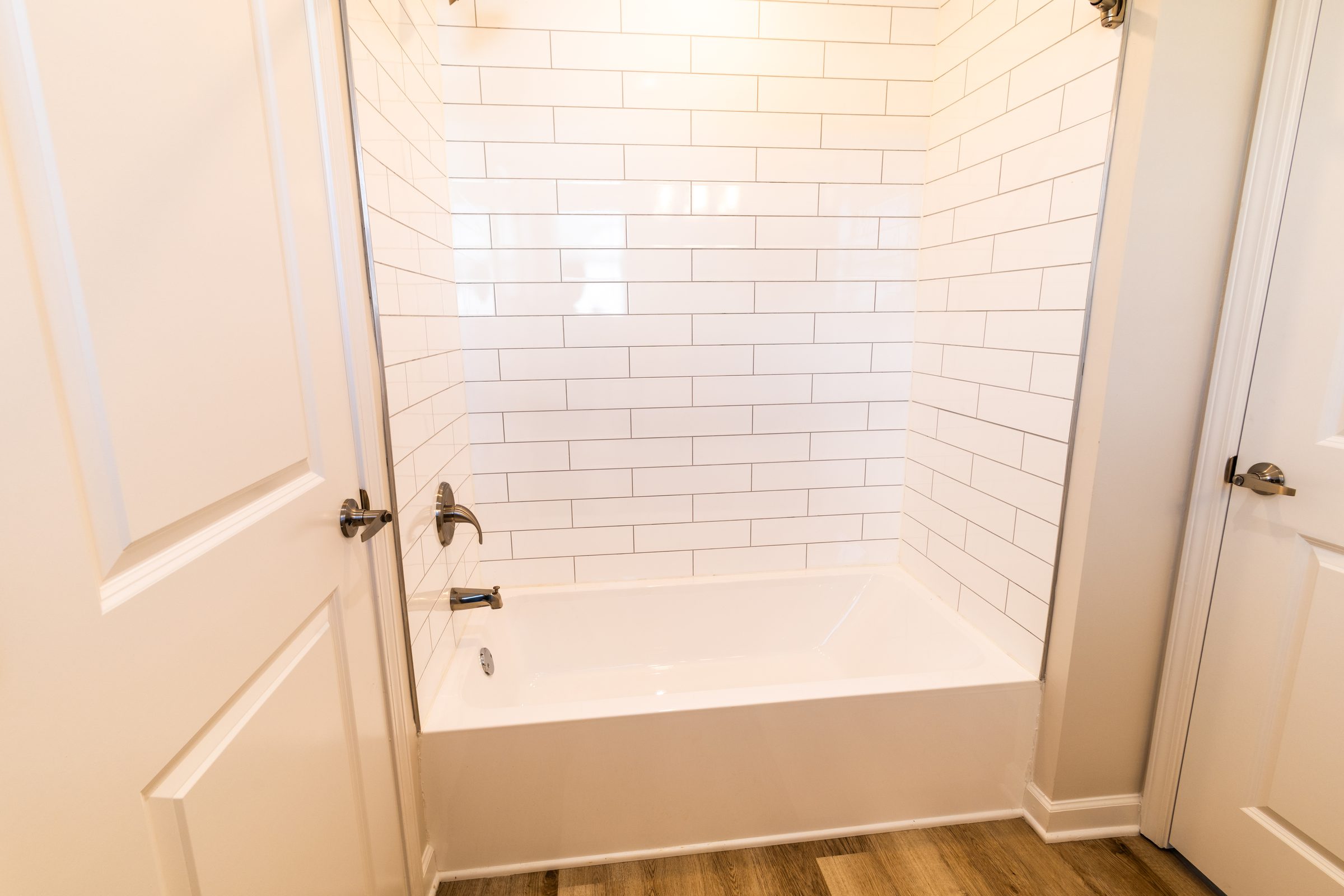 Bathroom with white subway tile tub surround