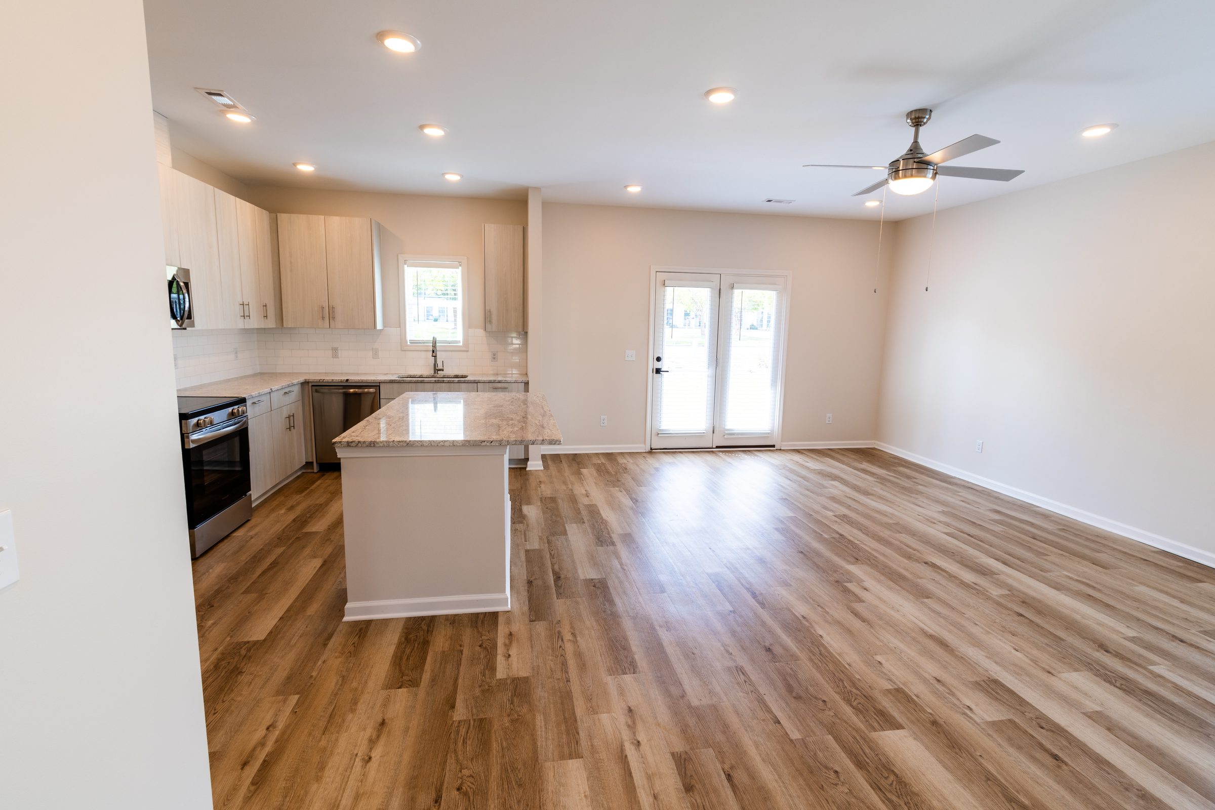Open-concept living room flowing into the kitchen
