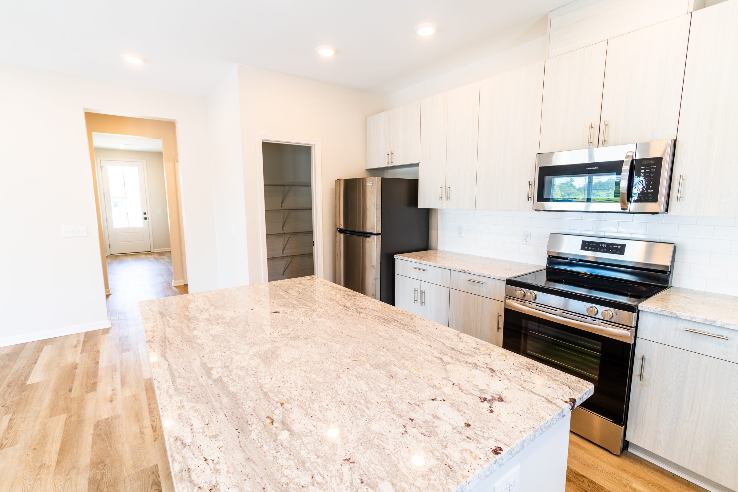 Kitchen island with granite countertops and stainless appliances
